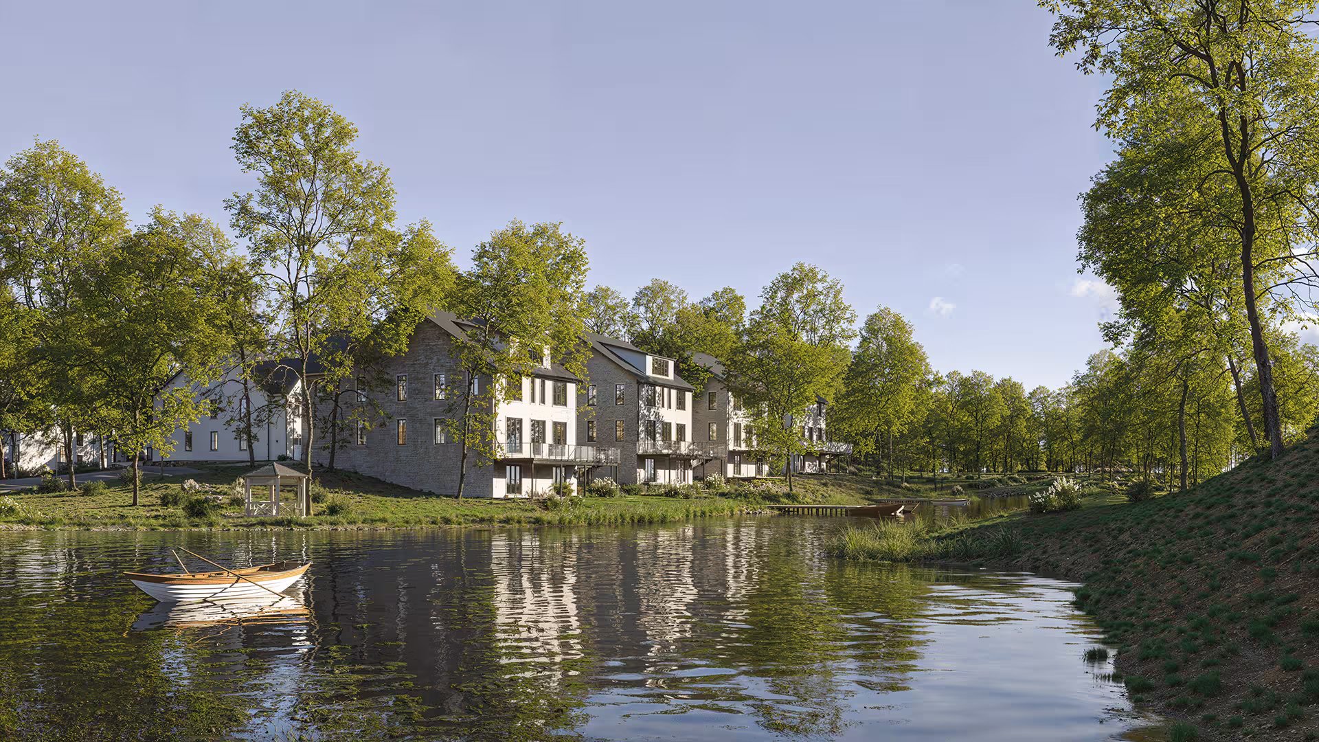 Waterfront perspective showing contemporary residential buildings near calm water surface